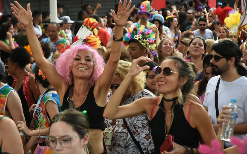 Smiling Carnival revelers dancing in the street